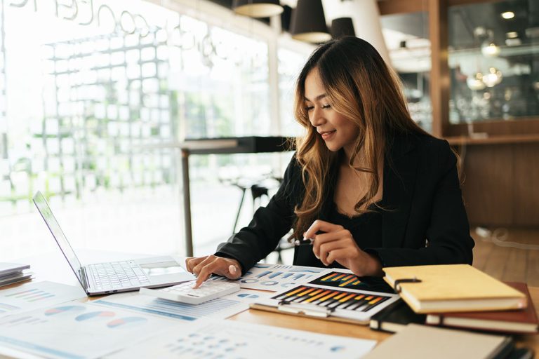 Smiling Young Asian Business women working with calculator, busi