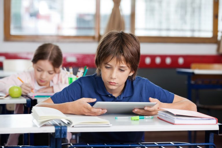 Schoolboy Using Digital Tablet At Desk