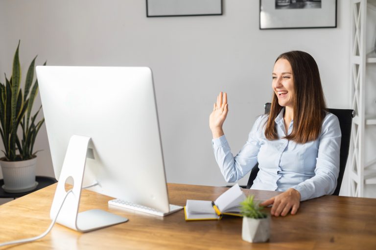 A young woman using PC for video call