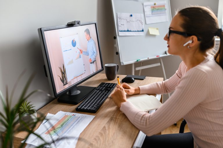 A woman in office is watching online classes