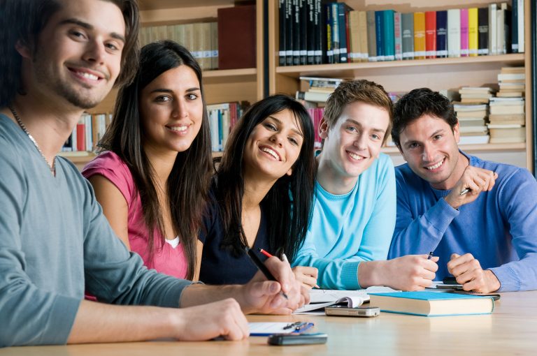 Smiling group of students in a library