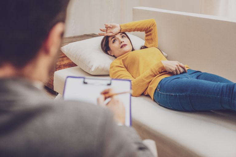 Pretty upset woman visiting psychologist